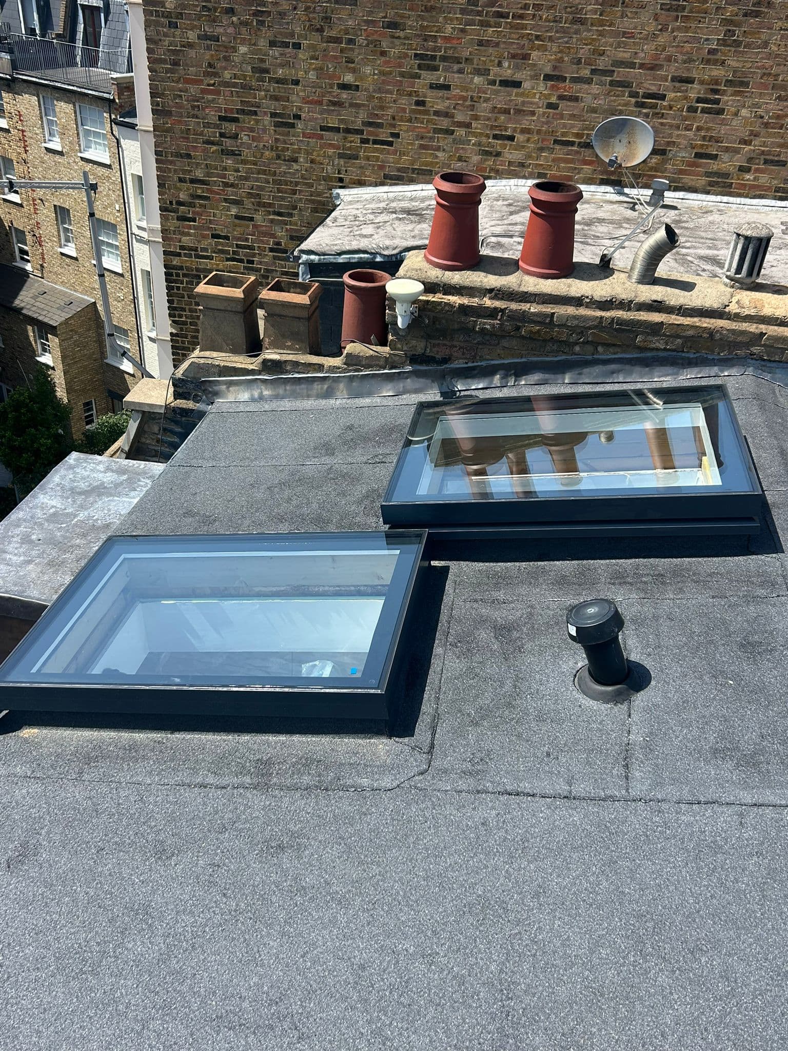 Two aluminium flat roof skylights installed on a central London flat felt roof