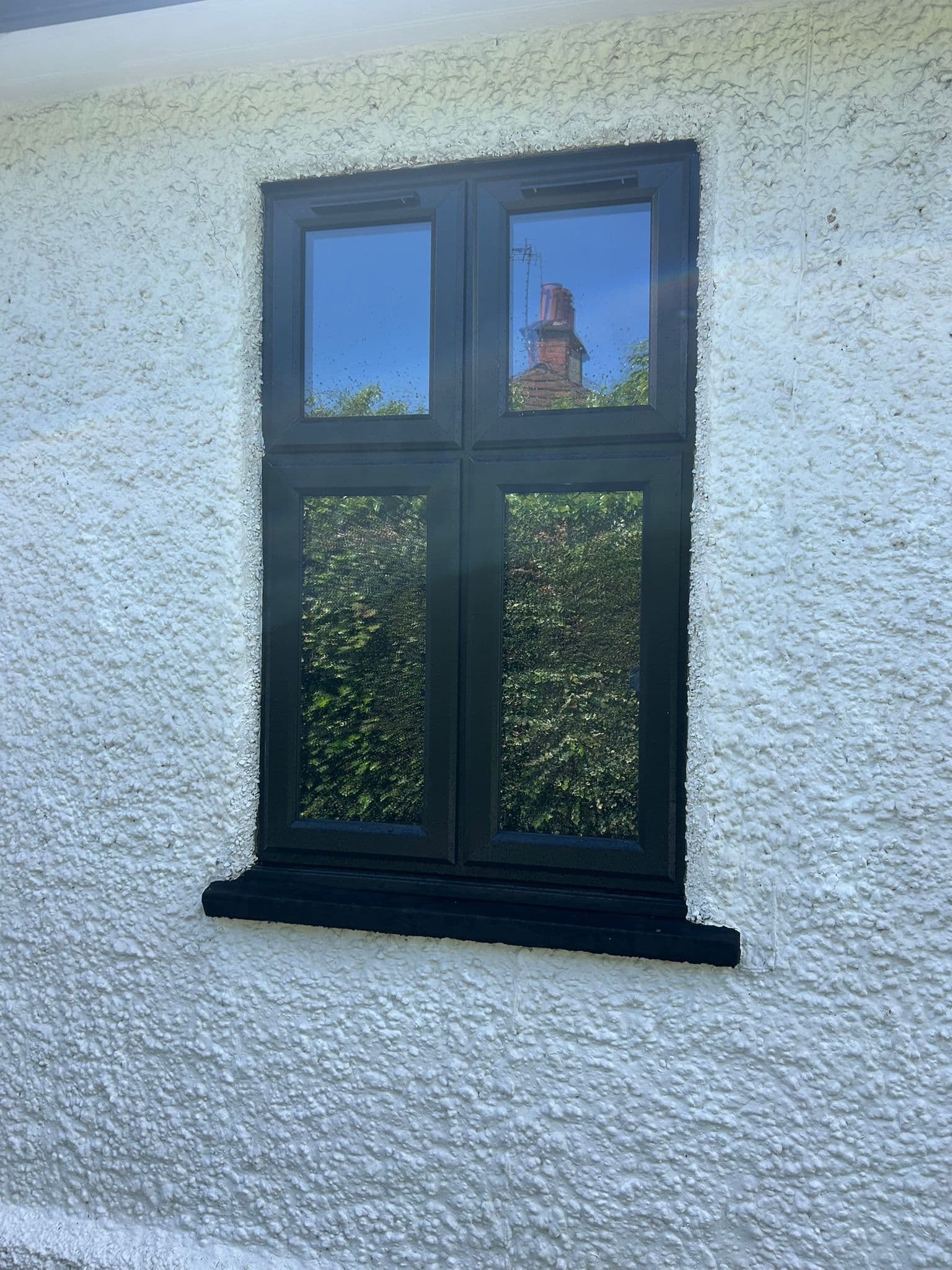 Casement window detail with black aluminium frame — The Gallop Sutton